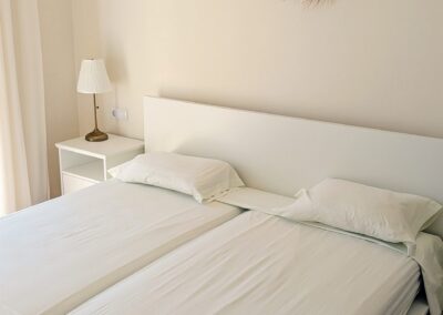 Schlafzimmer mit Doppelbett in warmen Cremetönen